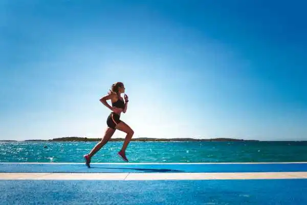 Woman running showing strong leg muscle Surrey